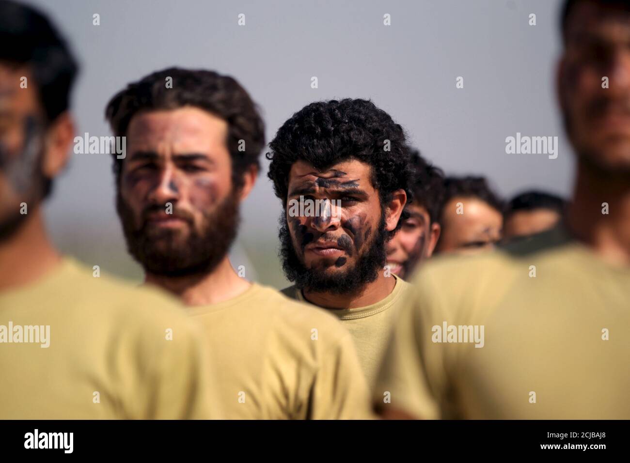 Rebel fighters take part in a military display as part of a graduation ceremony at a camp in the north of Hama province, Syria, March 31, 2016. REUTERS/Khalil Ashawi Stock Photo