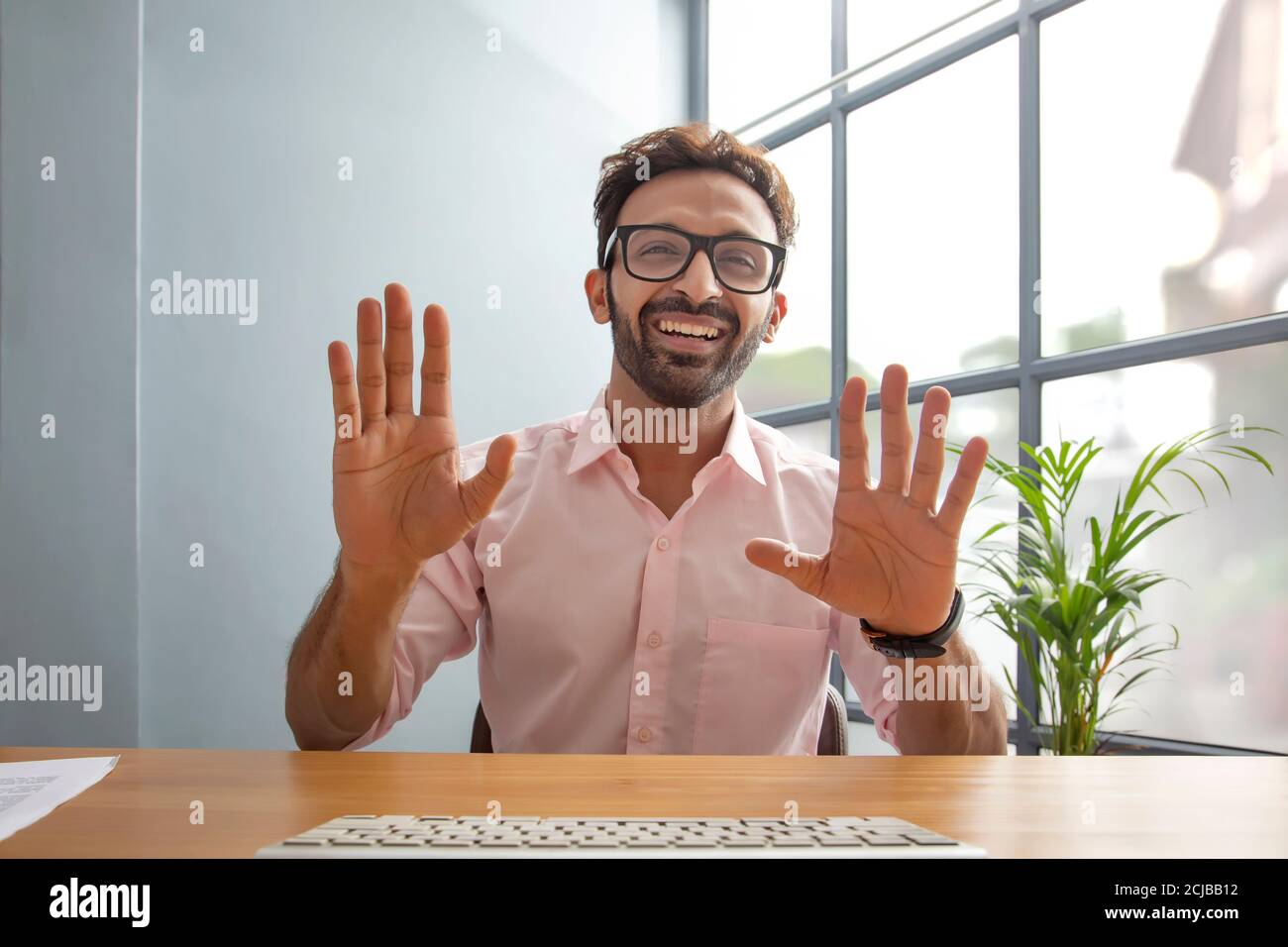 Young man gesturing while talking on video call Stock Photo