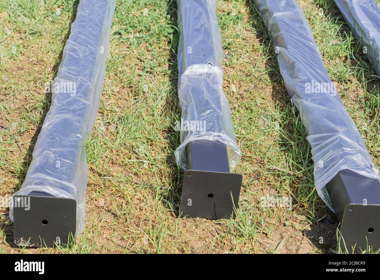 new metal piles in plastic package on construction site. Steel materials. Construction supplies Stock Photo