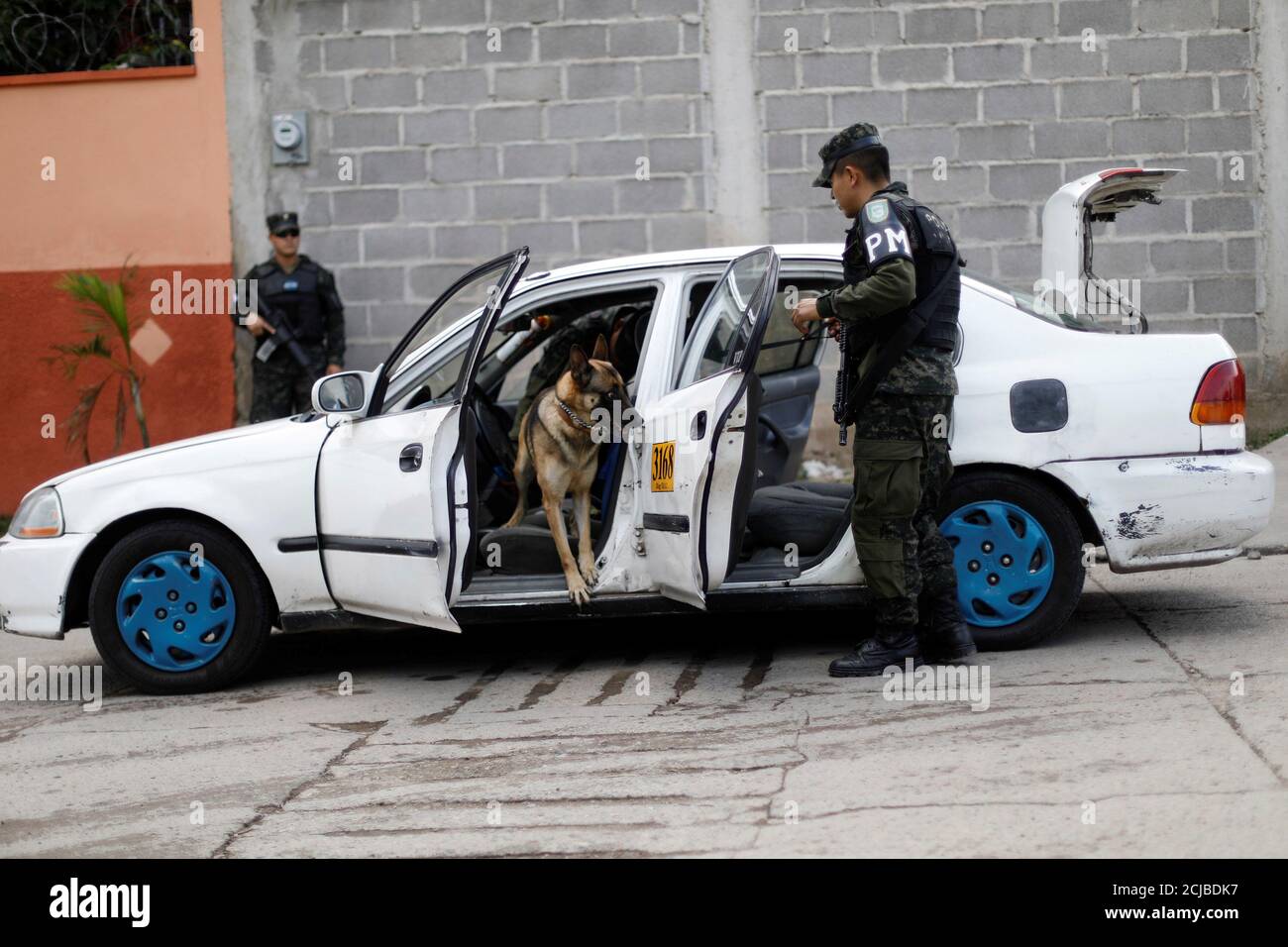 A soldier checks a car at a security post along a street as part of security measures for the November 26 presidential election in Tegucigalpa, Honduras November 23, 2017. REUTERS/Edgard Garrido Stock Photo