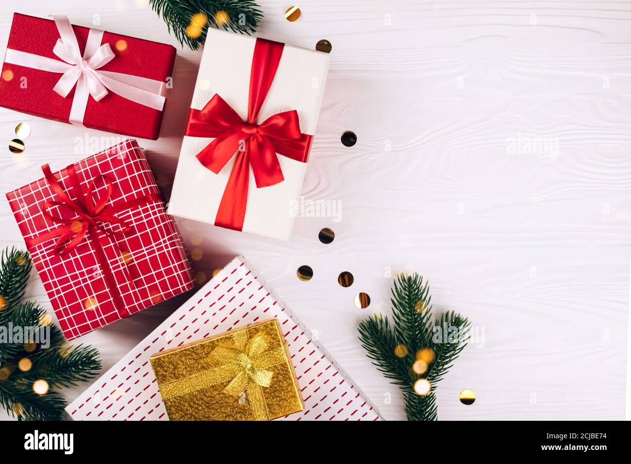 Festive gift boxes on wooden white background Stock Photo - Alamy