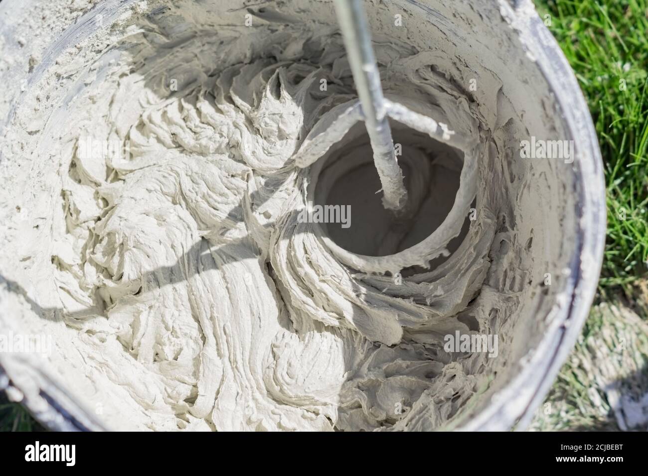 mixing tile adhesive or cement with a power drill for repair works on