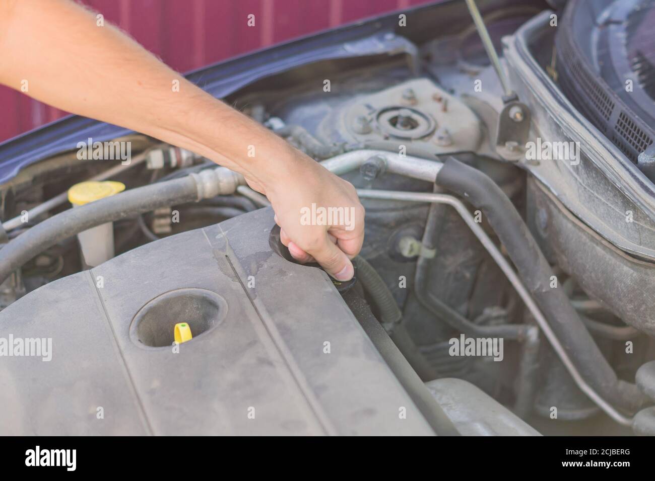 Mechanic checking and fixing an oil filler cap of a broken car on the road Stock Photo Alamy