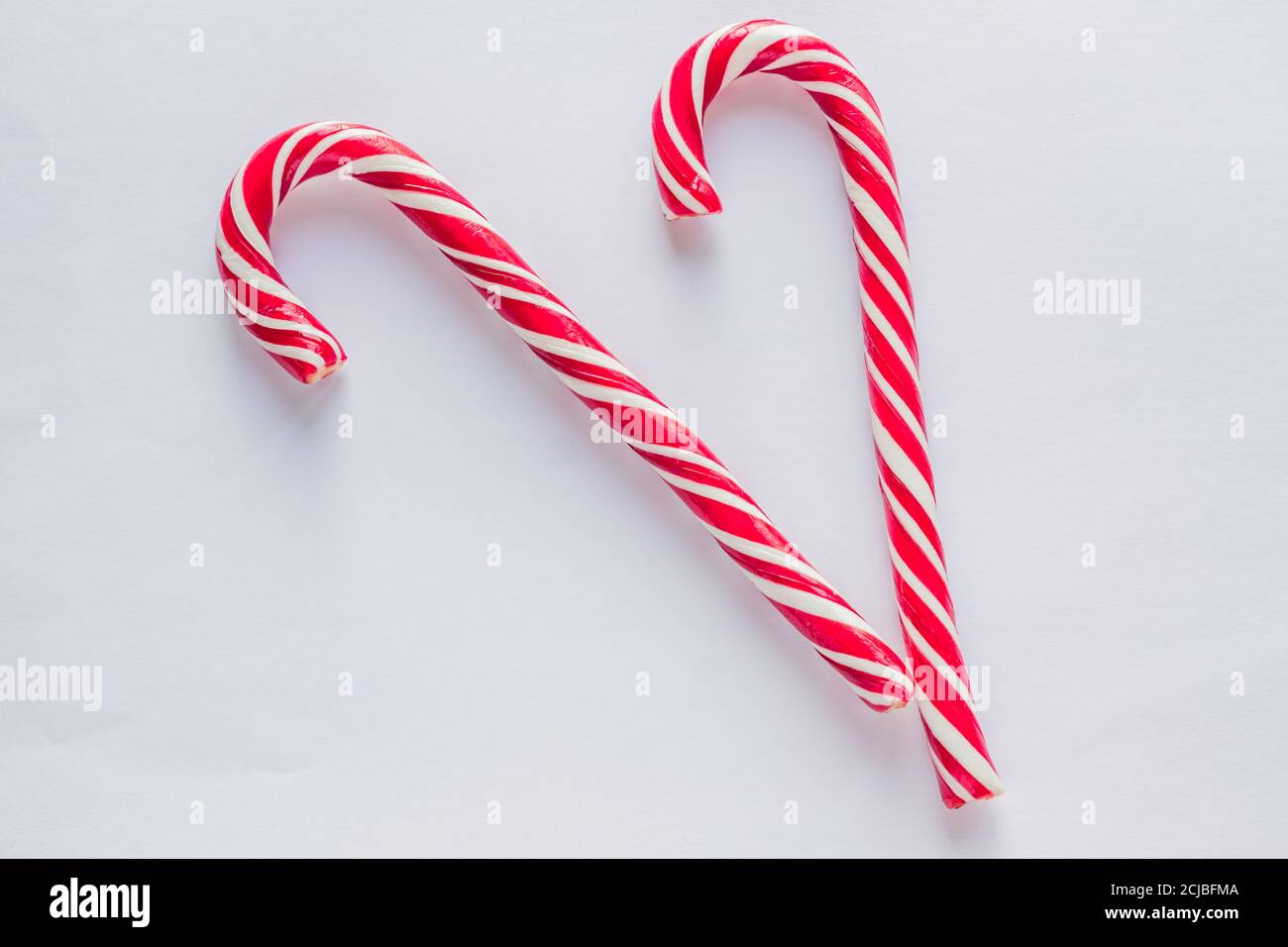two candy canes on white background. Traditional Christmas candies
