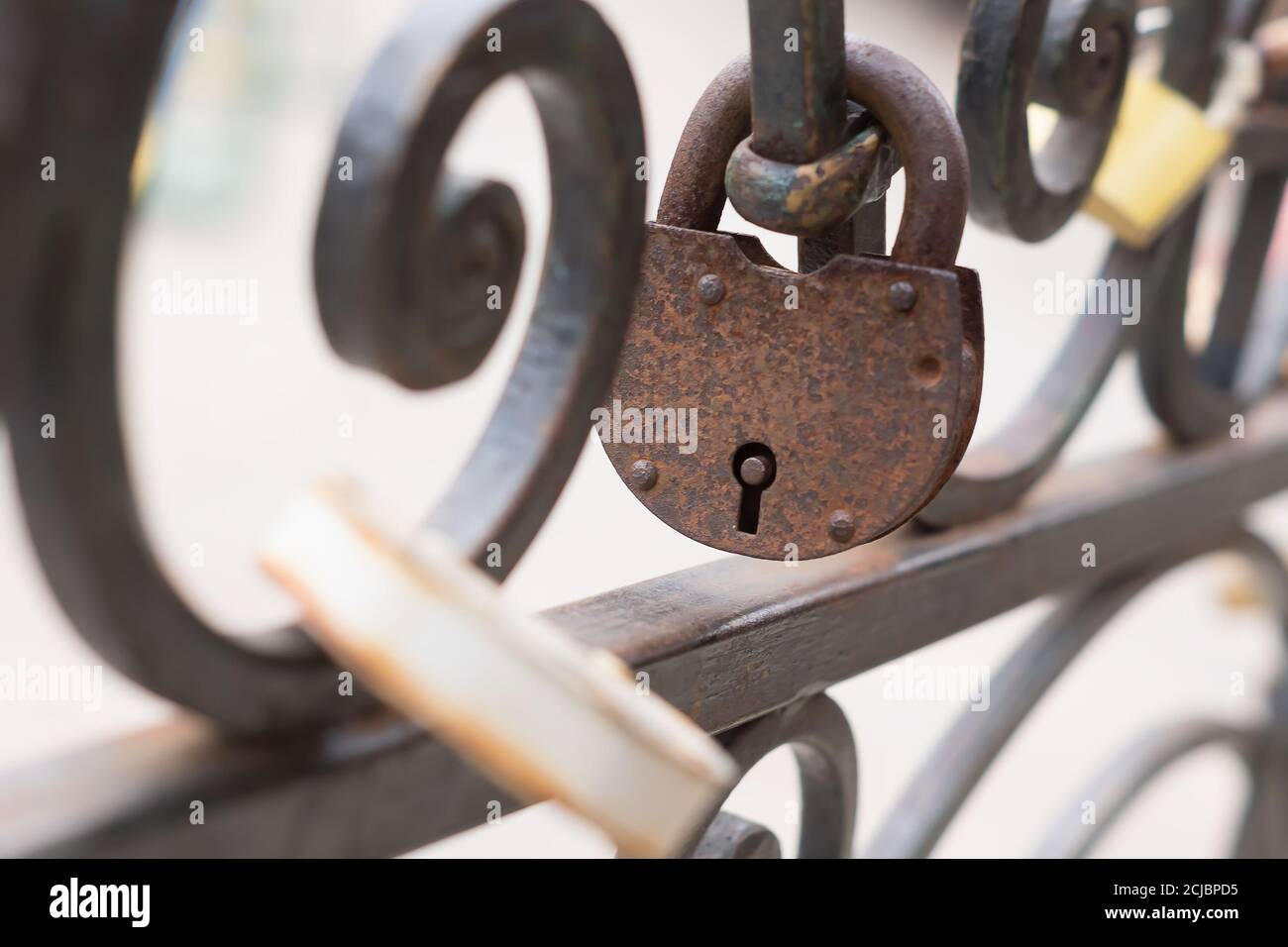 old rusty Padlock on iron fence. Selective focus. Stock Photo