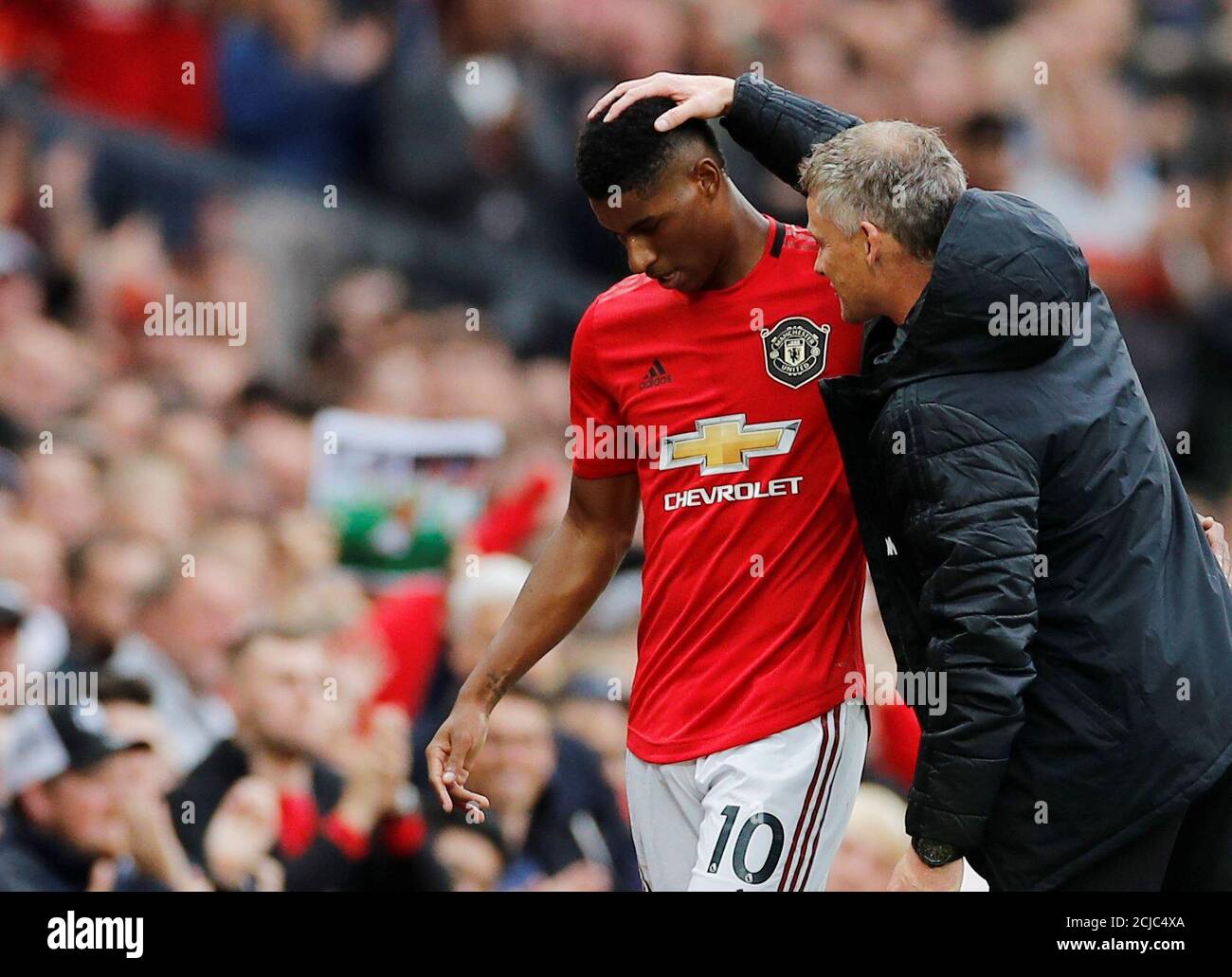 Soccer Football - Premier League - Manchester United v Chelsea - Old Trafford, Manchester, Britain - August 11, 2019  Manchester United's Marcus Rashford is congratulated by manager Ole Gunnar Solskjaer as he is substituted  REUTERS/Phil Noble  EDITORIAL USE ONLY. No use with unauthorized audio, video, data, fixture lists, club/league logos or 'live' services. Online in-match use limited to 75 images, no video emulation. No use in betting, games or single club/league/player publications.  Please contact your account representative for further details. Stock Photo