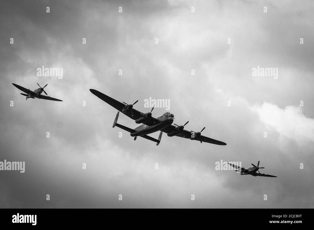 The Lancaster flies past escorted by two Spitfires Stock Photo