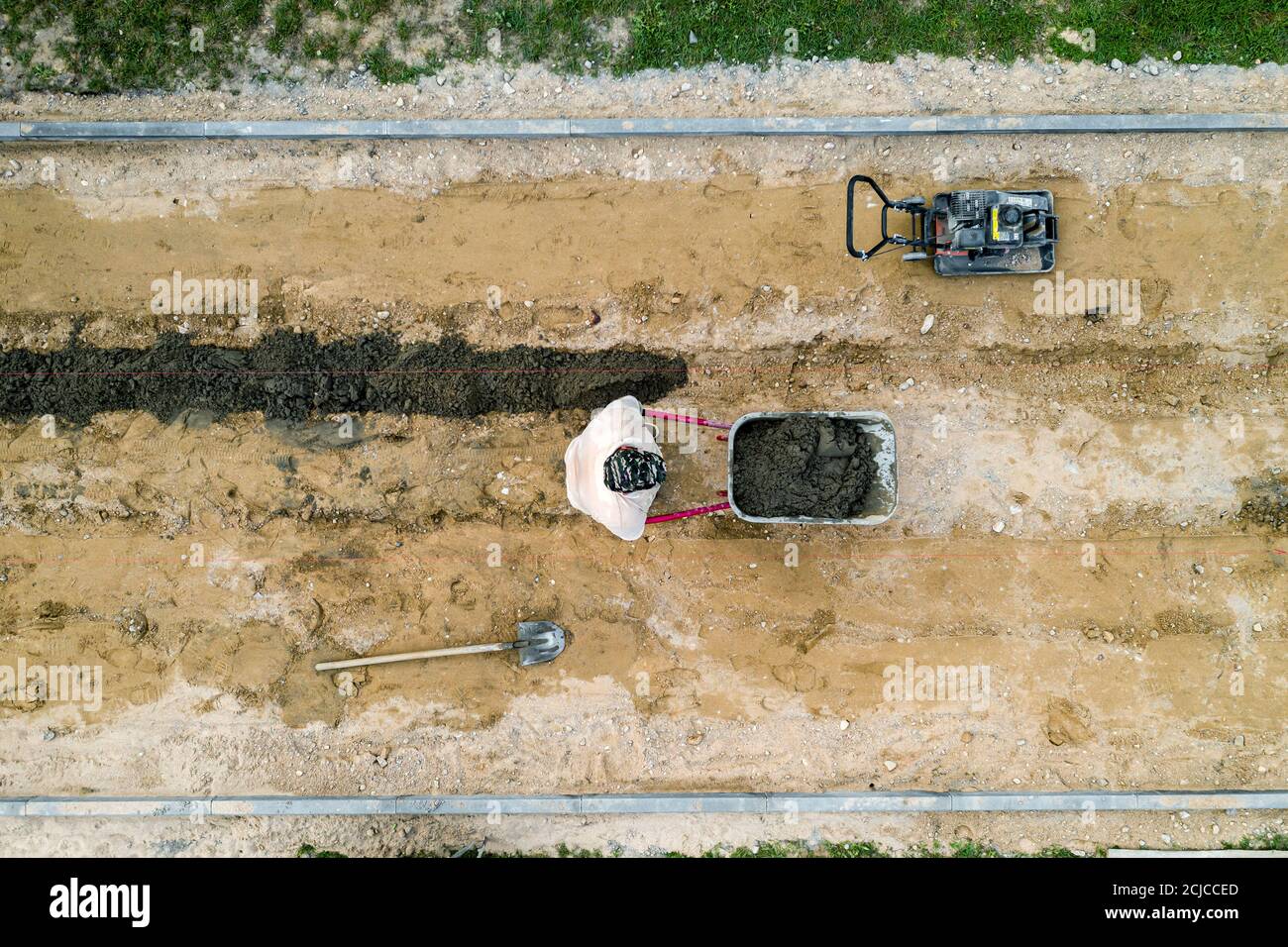 workers lay paving tiles top view from a drone. Stock Photo