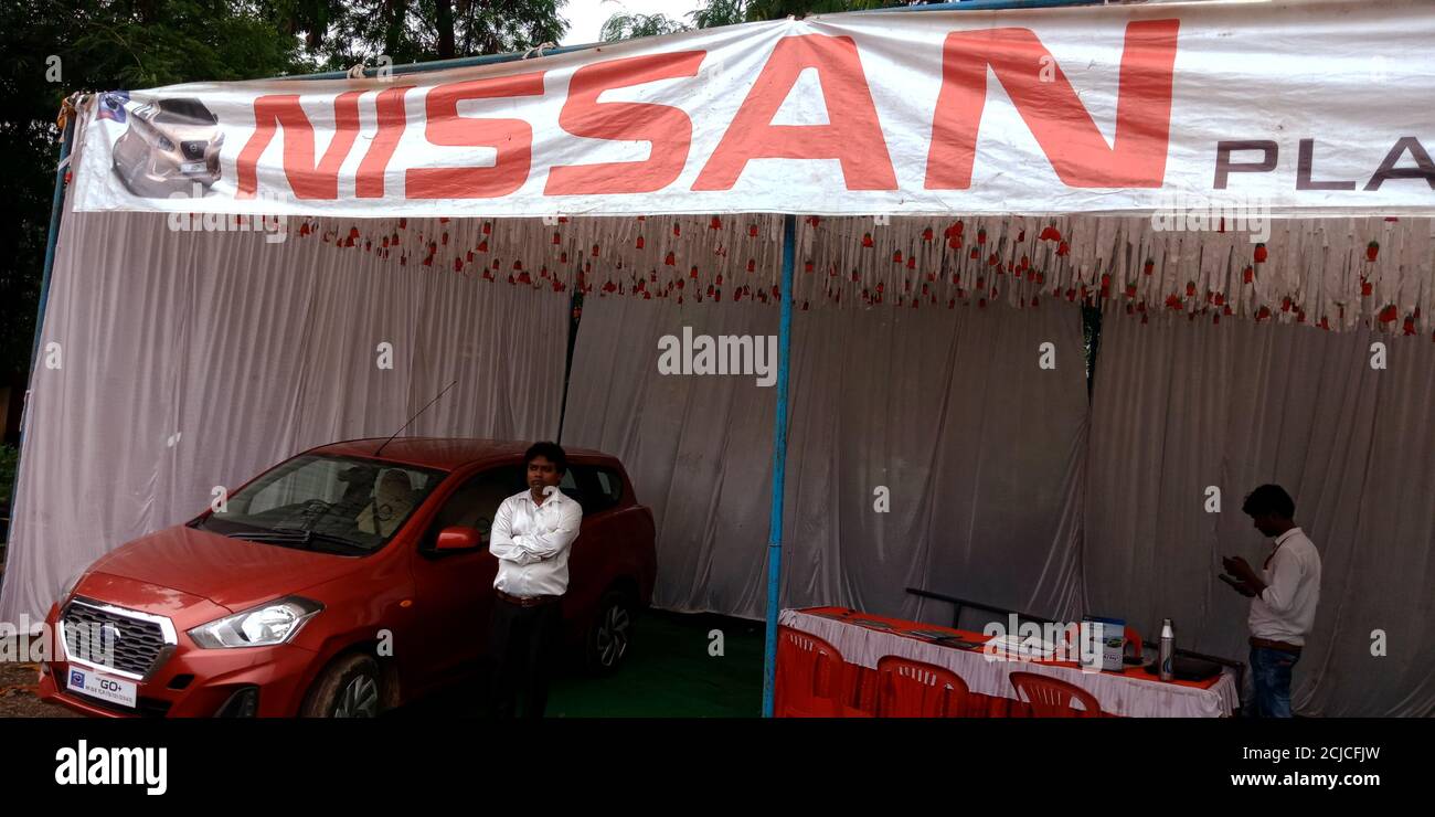 DISTRICT KATNI, INDIA - SEPTEMBER 16, 2019: An indian automobile male sales executive presenting NISSAN brand car model for street promotion events. Stock Photo