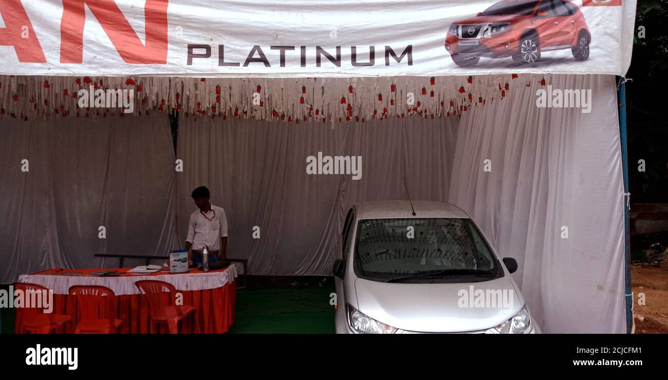 DISTRICT KATNI, INDIA - SEPTEMBER 16, 2019: An indian automobile male sales person presenting NISSAN brand car model for street promotion events. Stock Photo