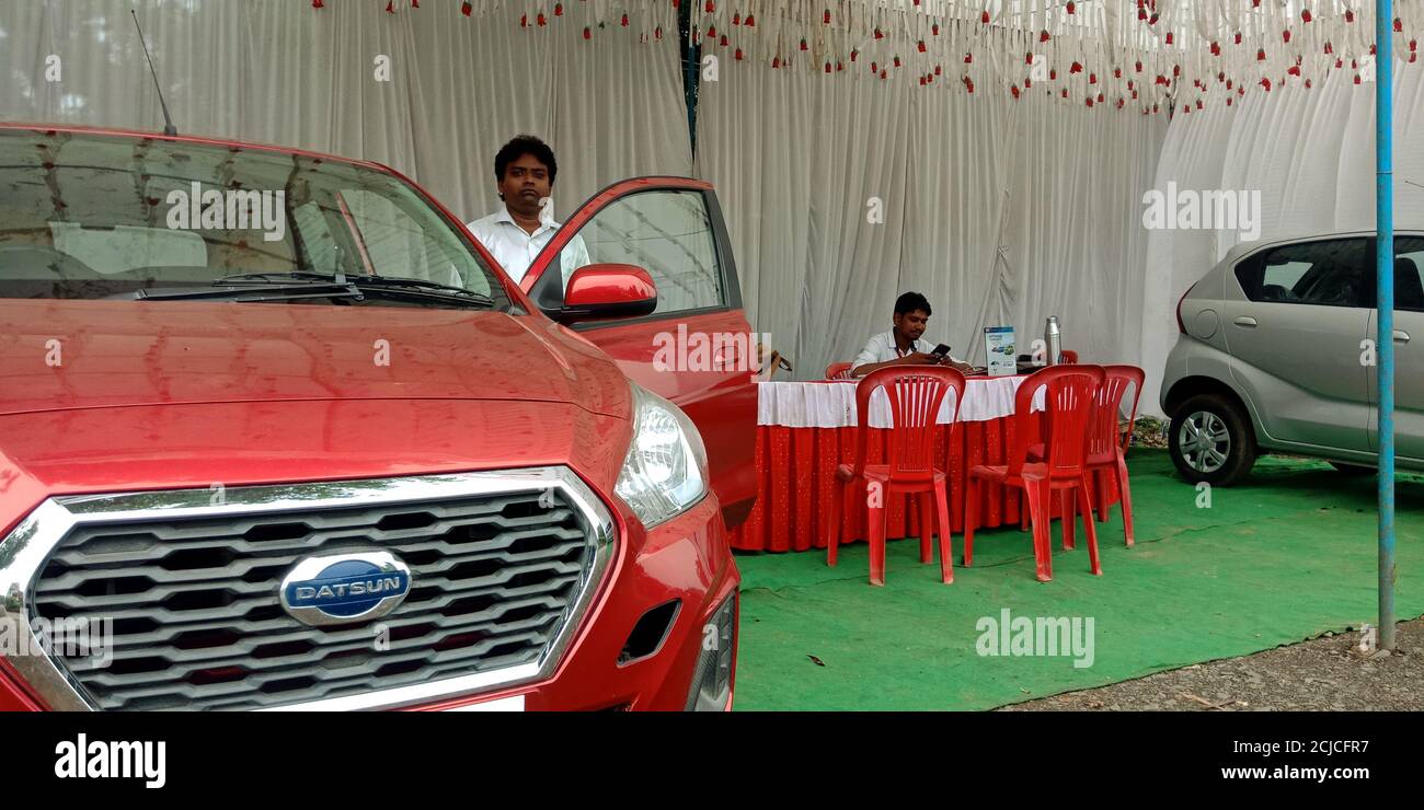 DISTRICT KATNI, INDIA - SEPTEMBER 16, 2019: An indian automobile sales executive staff presenting NISSAN brand car model for street promotion events. Stock Photo