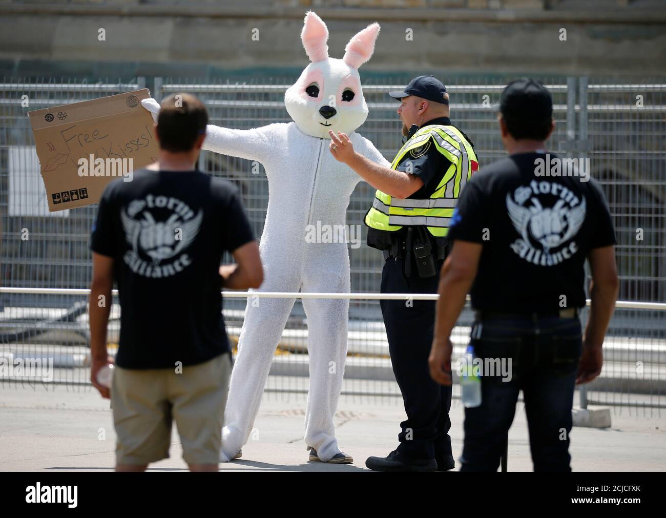 Protesters from the far-right group Storm Alliance look on as a counter-protester in a bunny costume gestures towards them during the 'Canadians for Canada' rally on Parliament Hill in Ottawa, Ontario, Canada, July 14, 2018. REUTERS/Chris Wattie Stock Photo