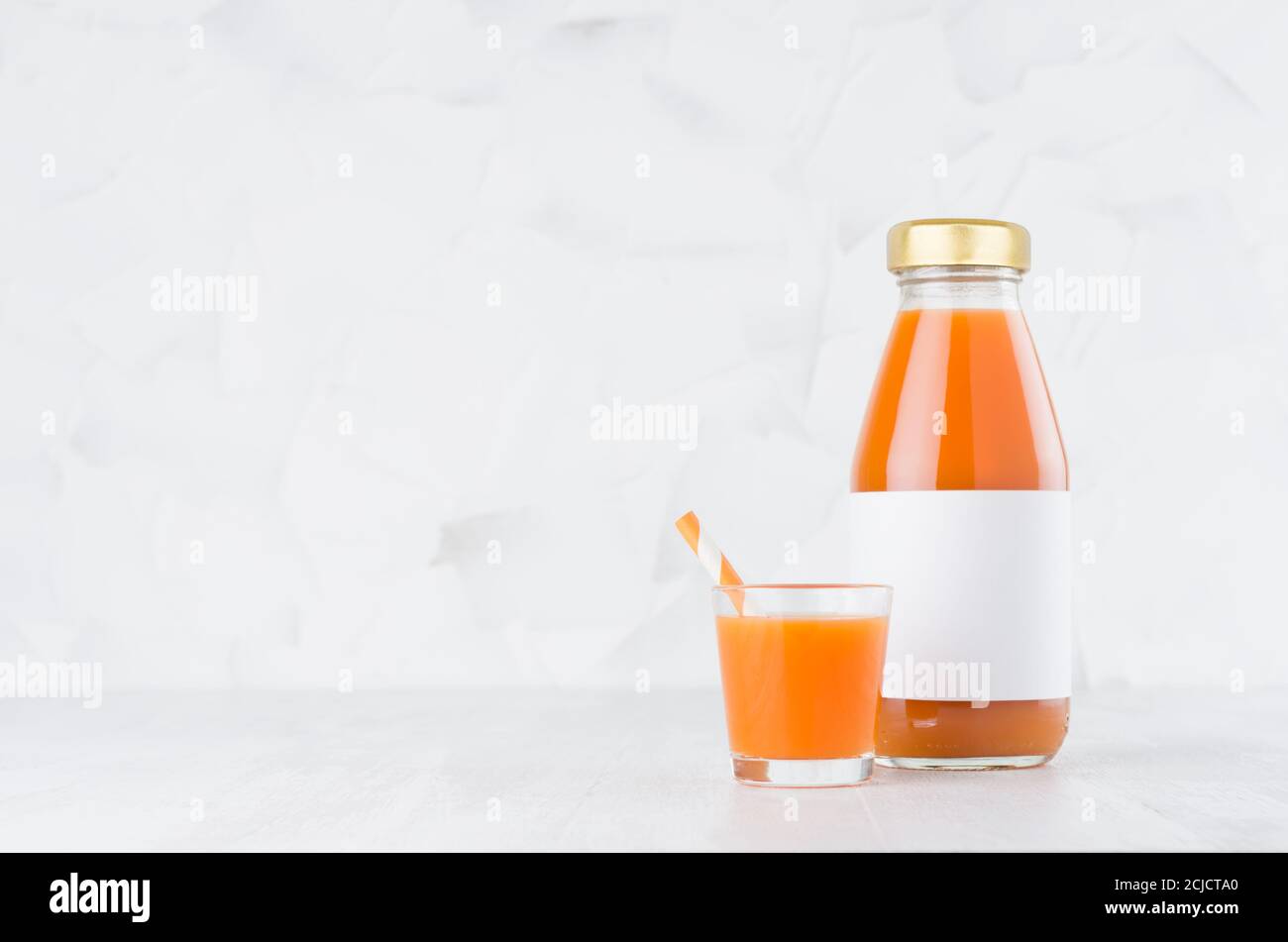 Download Vegetable Carrot Juice In Glass Bottle With Blank Label Mock Up With Glass Straw On Wood Table In White Interior Template For Packaging Advertising Stock Photo Alamy