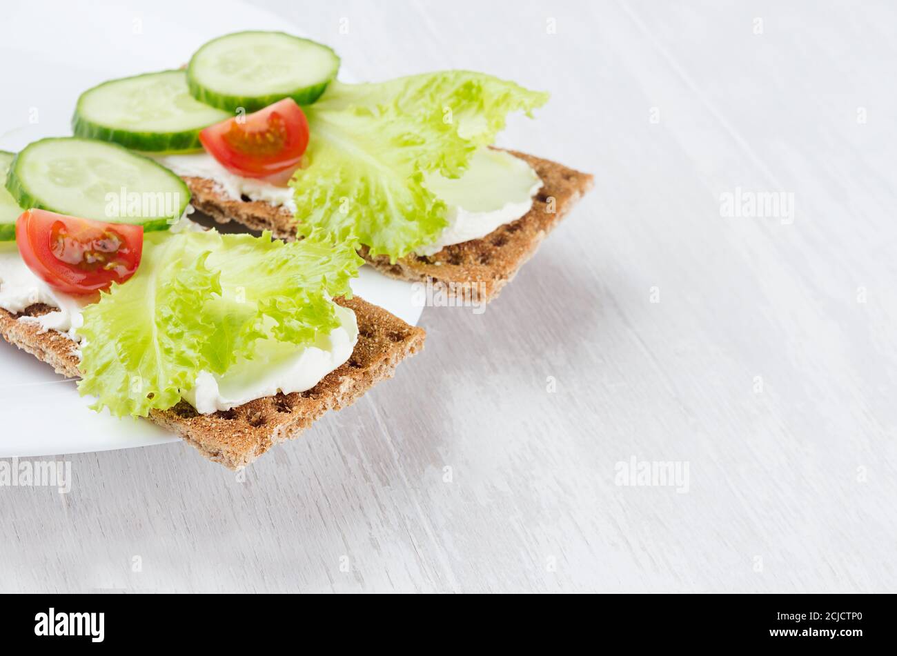 Fresh summer healthy appetizer of whole grain rye crisps breads with