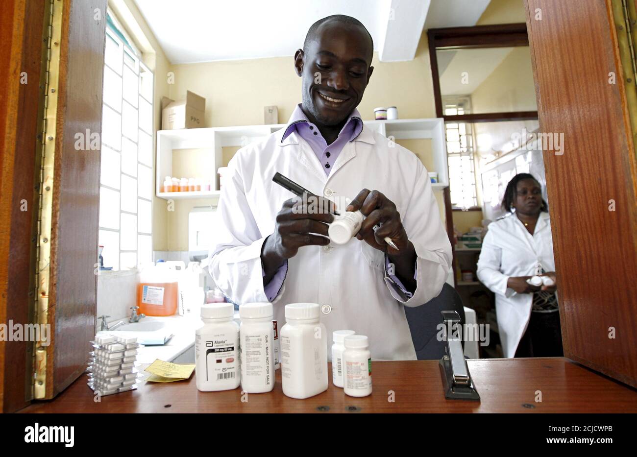 Michael Otieno, a pharmacist, dispenses anti-retroviral (ARV) drugs at the Mater Hospital in Kenya's capital Nairobi, September 10, 2015. Most of the 3,000 patients at Mater Hospital's Comprehensive Care Clinic, dedicated to HIV/AIDS treatment, come from nearby shanty towns. In Kenya, HIV prevalence among adults has almost halved since the mid-1990s to 5.3 percent in 2014, according to UNAIDS. Yet HIV/AIDS remains the leading cause of death in Kenya, responsible for nearly three in 10 deaths in the east African country, where 1.6 million Kenyans are infected, government data in 2014 shows. Pic Stock Photo