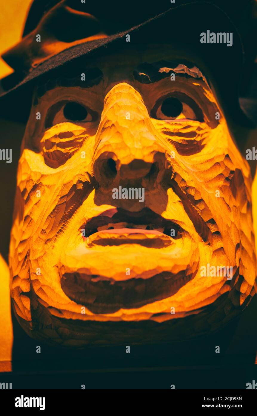 Traditional scary mask of a fat man in the traditional harvest festival in the Baltic countries in orange tones Stock Photo