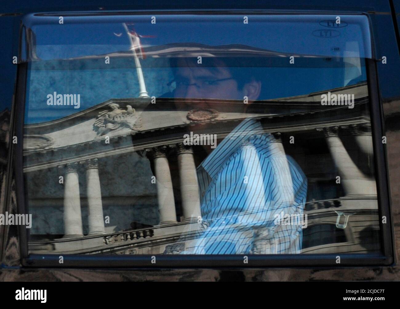 The Bank of England is reflected in a taxi window as it passes through the City of London April 23, 2010. The economic recovery lost ground in the first three months of this year as the harshest winter in three decades hit retailers and industry, official data showed on Friday. REUTERS/Toby Melville (BRITAIN - Tags: BUSINESS) Stock Photo