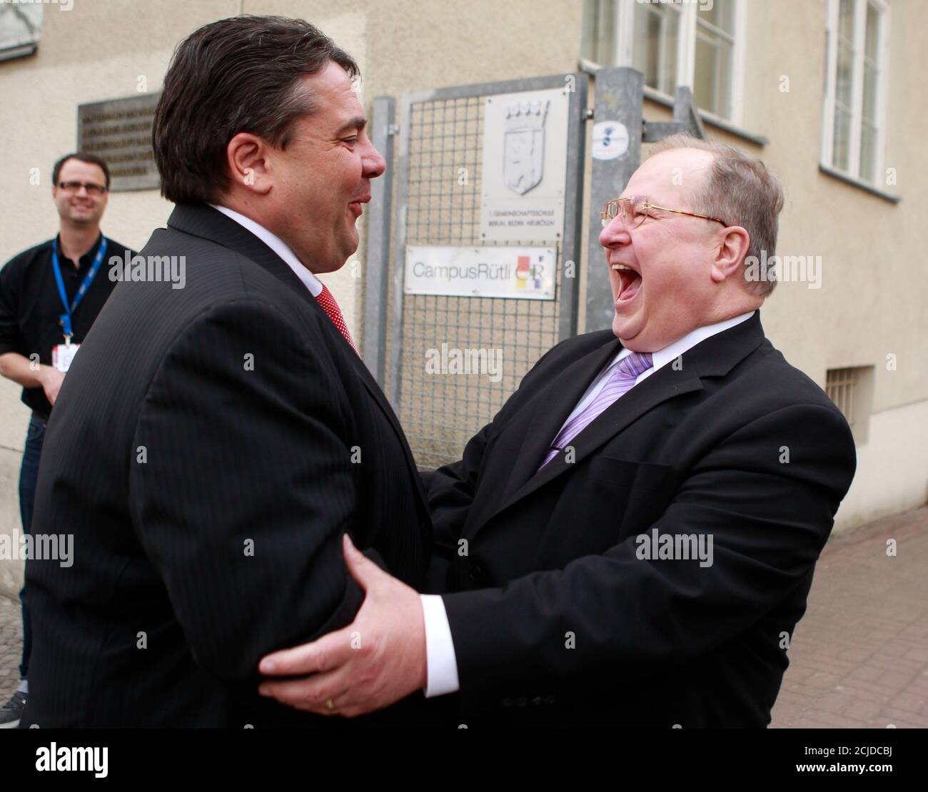 The district mayor of Berlin's Neukoelln borough and member of the Social Democratic Party (SPD) Heinz Buschkowsky (R) welcomes SPD leader Sigmar Gabriel to a local SPD meeting at the Ruetli School in Berlin, April 11, 2011.  The multi-ethnic district of Neukoelln is considered one of the poorest of the German capital, where voters will elect a new mayor later this year.   REUTERS/Thomas Peter (GERMANY - Tags: POLITICS) Stock Photo