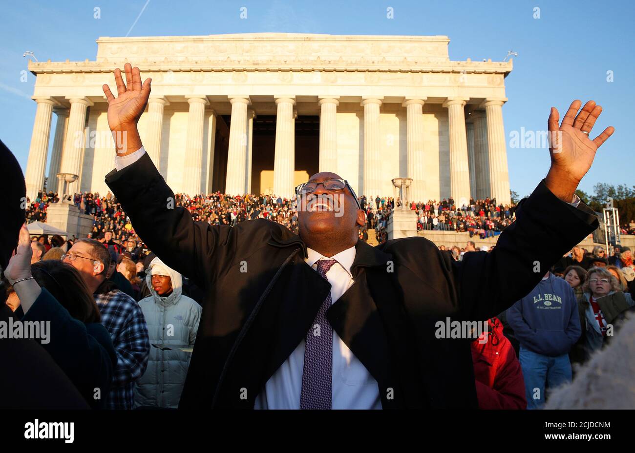 Christians pray during an Easter morning sunrise religious service on the steps of the Lincoln Memorial in Washington April 5, 2015. Organizers said an estimated 8,900 people attended the 37th occurrence of the annual event in front of the memorial which was dedicated to the former president in 1922. On April 15, the United States commemorates the 150th anniversary of President Abraham Lincoln's assassination. REUTERS/Jim Bourg Stock Photo