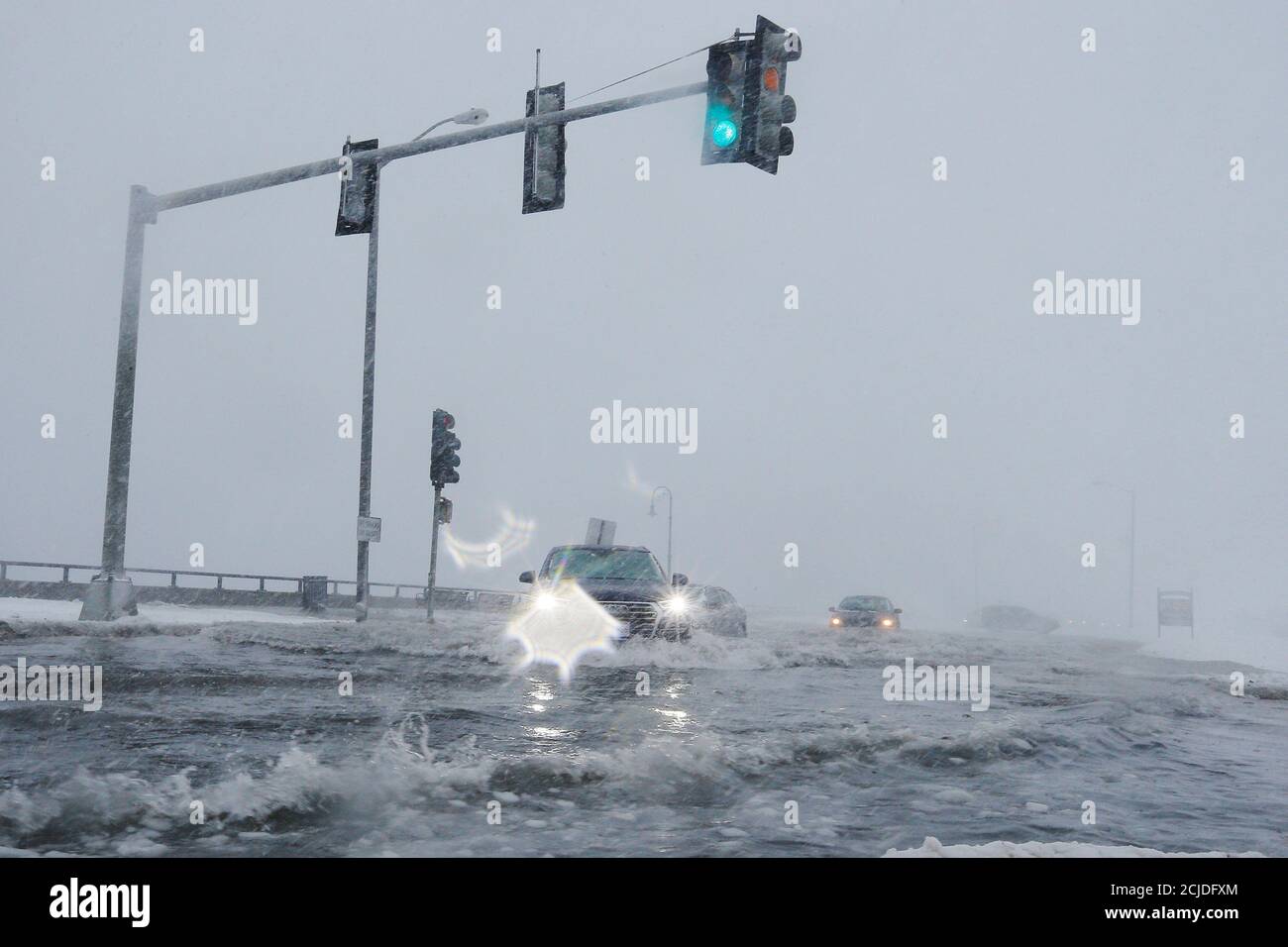 Drivers make their way along the flooded Beach Road after the ocean overtopped the seawall during a winter snowstorm in the Boston suburb of Lynn, Massachusetts, U.S., January 4, 2018. REUTERS/Brian Snyder Stock Photo
