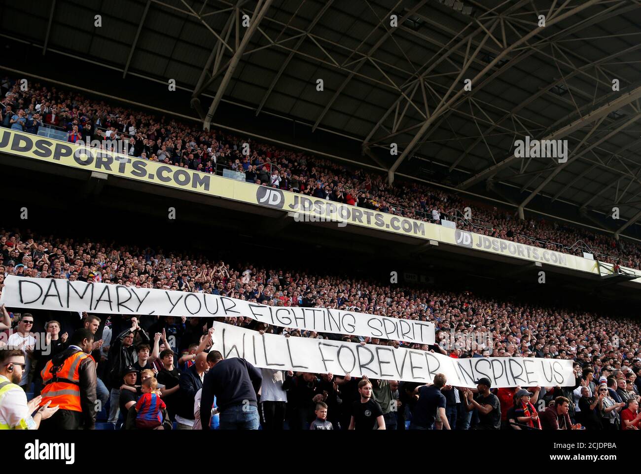 Soccer Football - Premier League - Crystal Palace v Huddersfield Town - Selhurst Park, London, Britain - March 30, 2019  Fans inside the stadium hold banners in memory of Damary Dawkins during the match     Action Images via Reuters/Andrew Couldridge  EDITORIAL USE ONLY. No use with unauthorized audio, video, data, fixture lists, club/league logos or 'live' services. Online in-match use limited to 75 images, no video emulation. No use in betting, games or single club/league/player publications.  Please contact your account representative for further details. Stock Photo