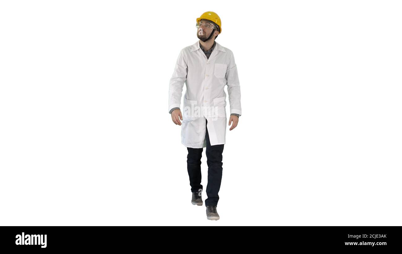 Engineer putting on protactive glasses while walking on white ba Stock Photo