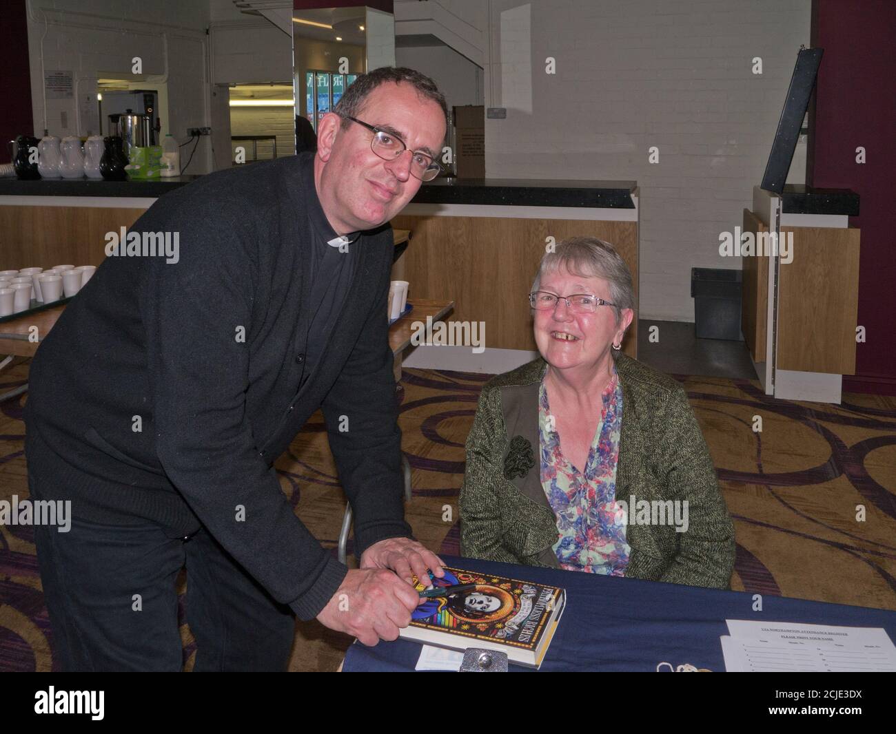 Reverend Richard Coles signs a copy of his autobiography for a female fan, Northampton, UK Stock Photo