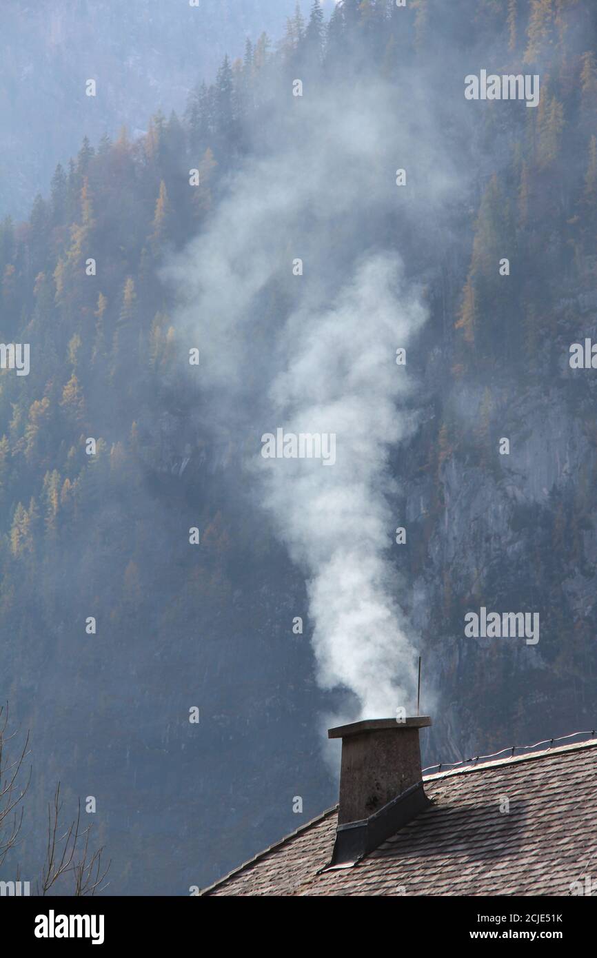 Vertical shot of smoke coming out the chimney Stock Photo