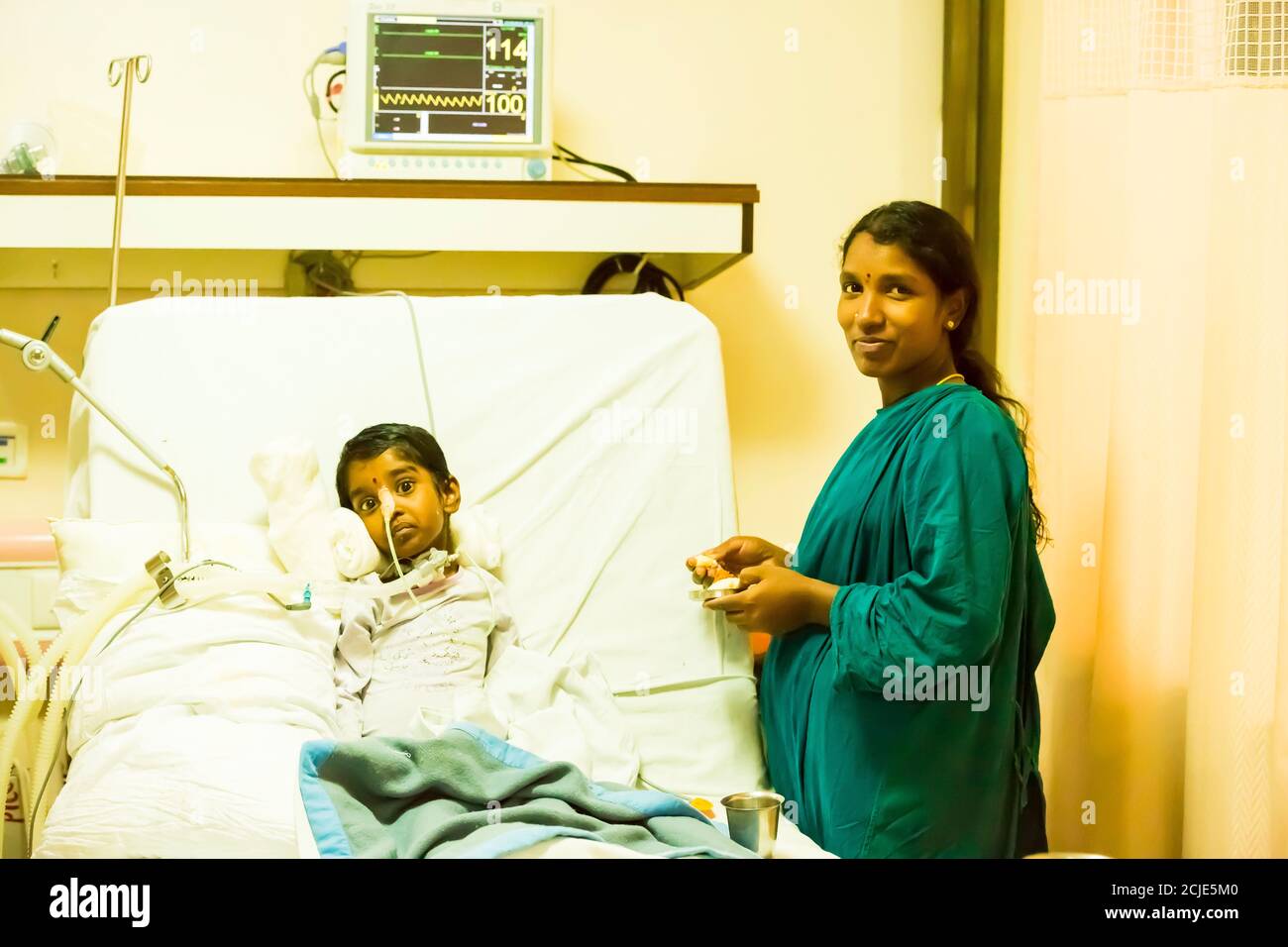 PUDUCHERRY, INDIA - MARCH Circa, 2020. Child with trachea placed on an artificial lung ventilation equipment in indian hospital. Pneumonia diagnosting Stock Photo