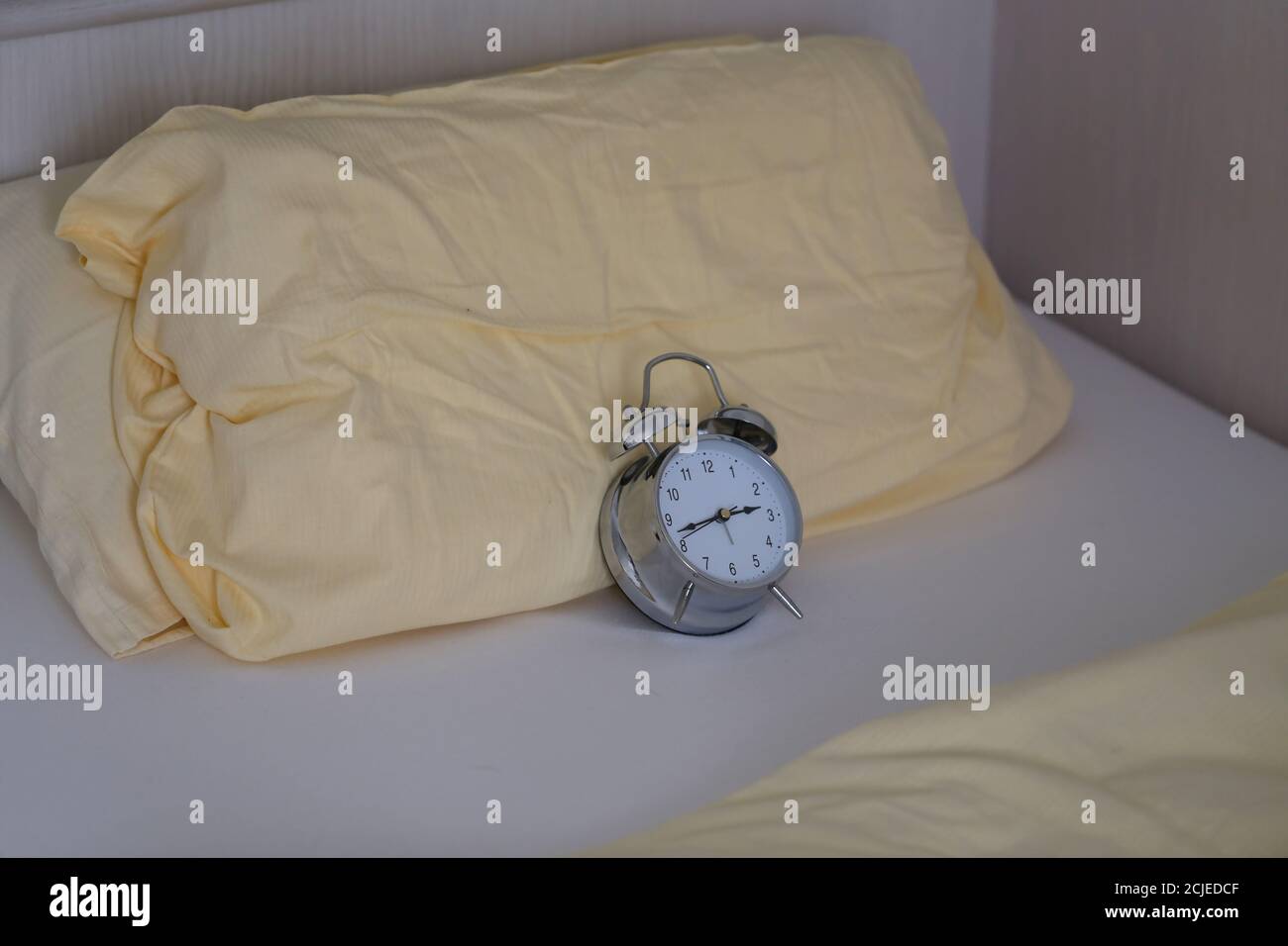 Alarm on a bed concept of waking up early Stock Photo Alamy