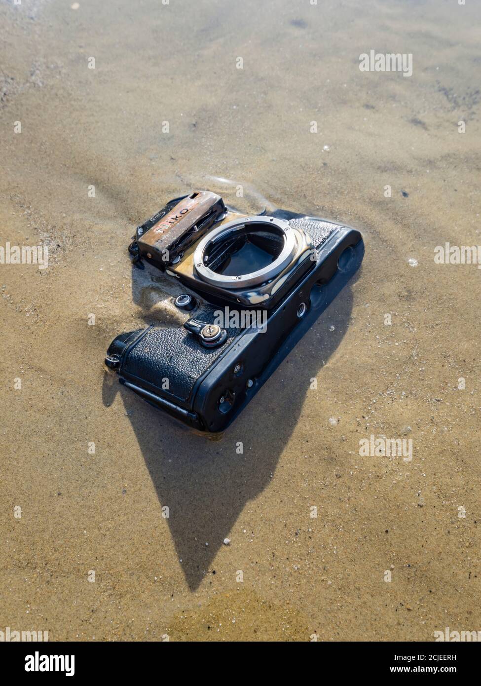 Nikon retro classic SLR film camera on beach Stock Photo