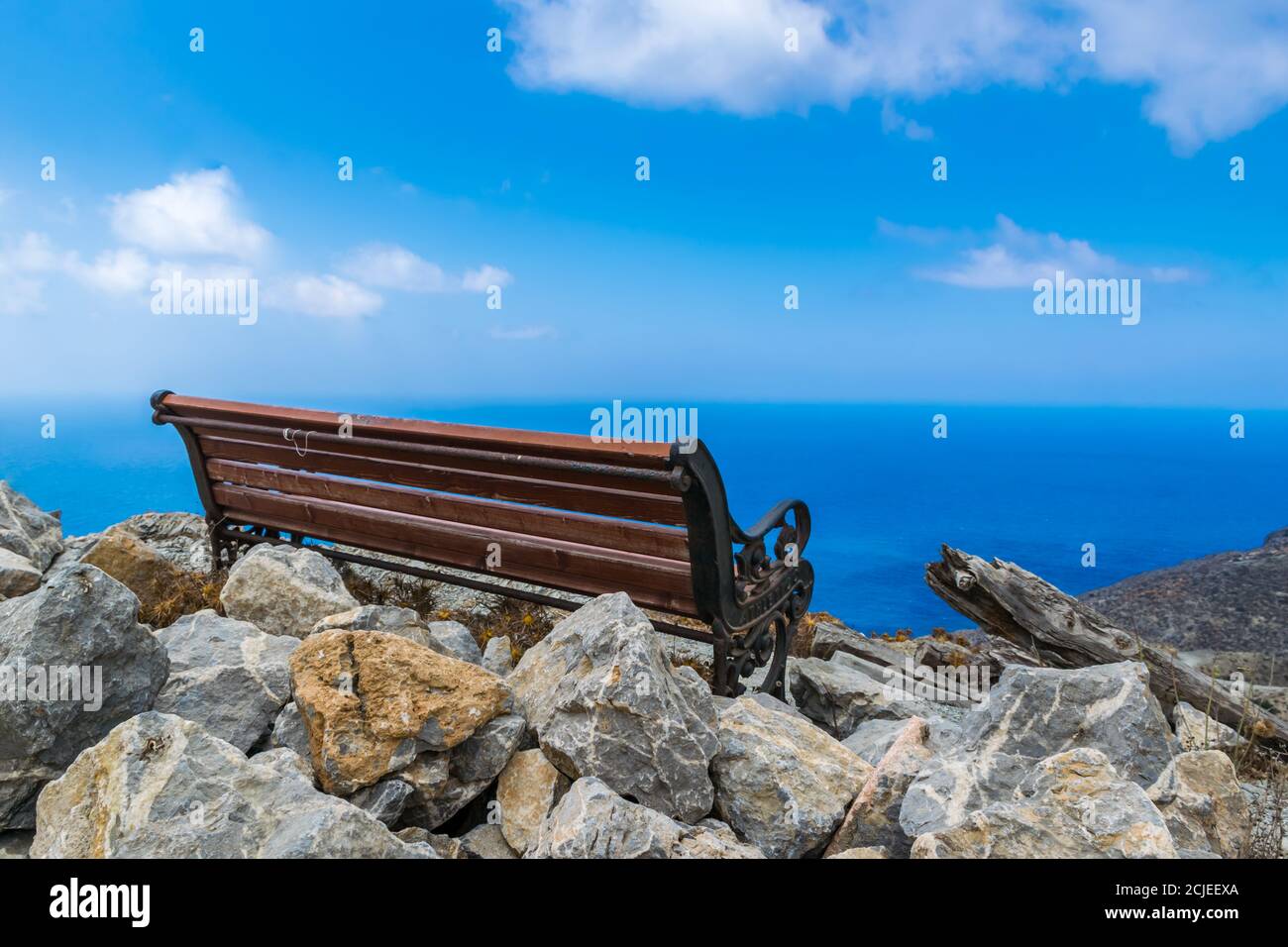 Wooden Bench on Hill Peak Overlooking Aegean Sea, Olympos, Karpathos, Greece Stock Photo