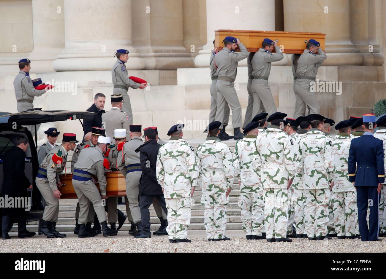 Soldiers carry the coffins of late thirteen French soldiers killed in Mali, before a ceremony at the Hotel National des Invalides in Paris, France, December 2, 2019. French soldiers Julien Carrette, Benjamin Gireud, Romain Salles de Saint-Paul, Clement Frison-Roche, Nicolas Megard, Romain Chomel de Jarnieu, Pierre Bockel, Alex Morisse, Jeremy Leusie, Alexandre Protin, Antoine Serre, Valentin Duval, Andrei Jouk died in Mali when their helicopters collided in the dark last week as they hunted for Islamist militants.   REUTERS/Charles Platiau Stock Photo