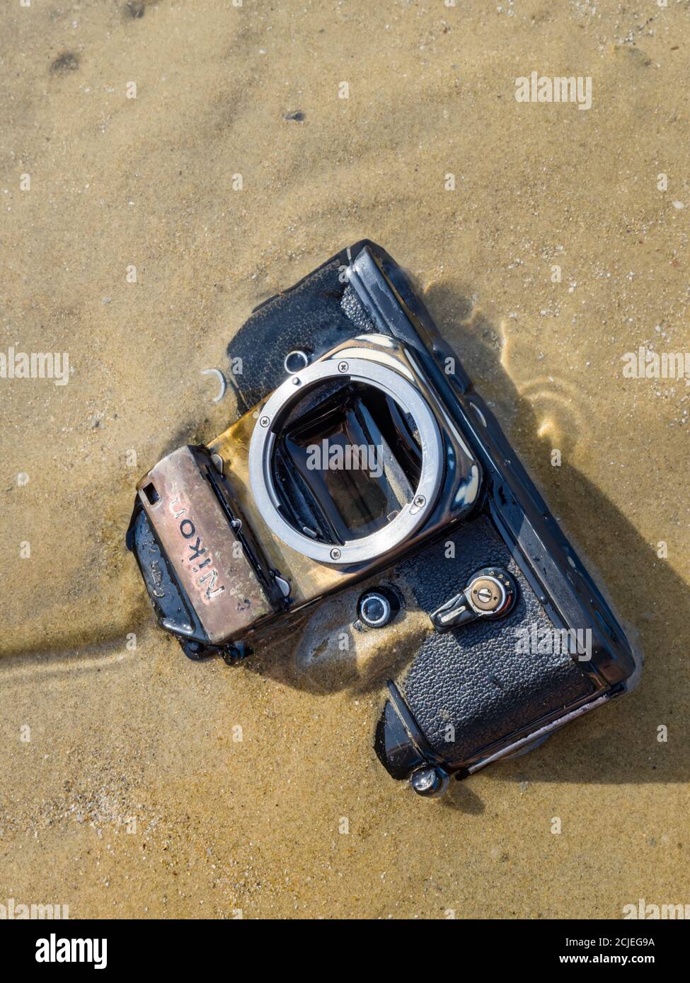 Nikon retro classic SLR film camera on beach Stock Photo