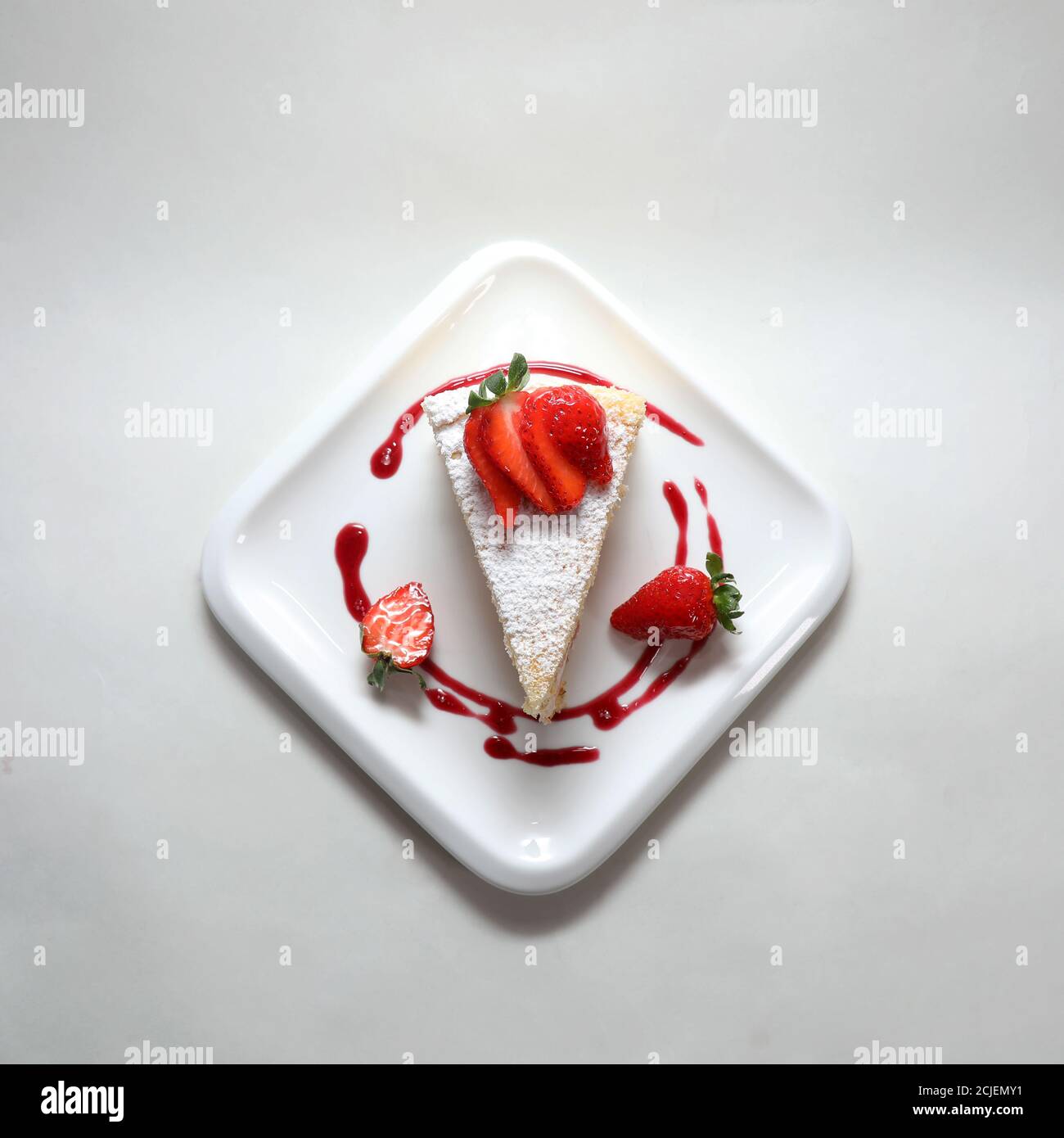 Top view of a piece of cake with strawberries on a plate isolated on a ...