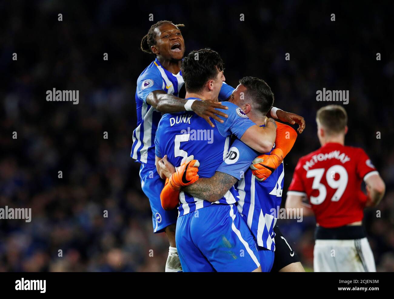Soccer Football - Premier League - Brighton & Hove Albion v Manchester United - The American Express Community Stadium, Brighton, Britain - May 4, 2018   Brighton's Gaetan Bong, Shane Duffy and Lewis Dunk celebrate after the match    REUTERS/Eddie Keogh    EDITORIAL USE ONLY. No use with unauthorized audio, video, data, fixture lists, club/league logos or 'live' services. Online in-match use limited to 75 images, no video emulation. No use in betting, games or single club/league/player publications.  Please contact your account representative for further details. Stock Photo