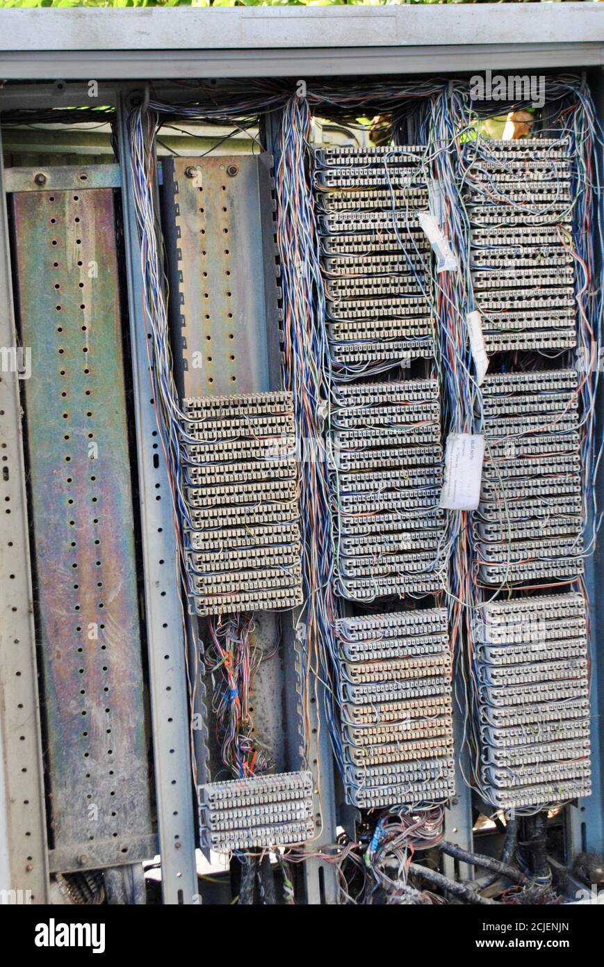 A vertical shot of the opened electric panel box and wires with different colors awaiting for inspection. Industrial electrical concept Stock Photo