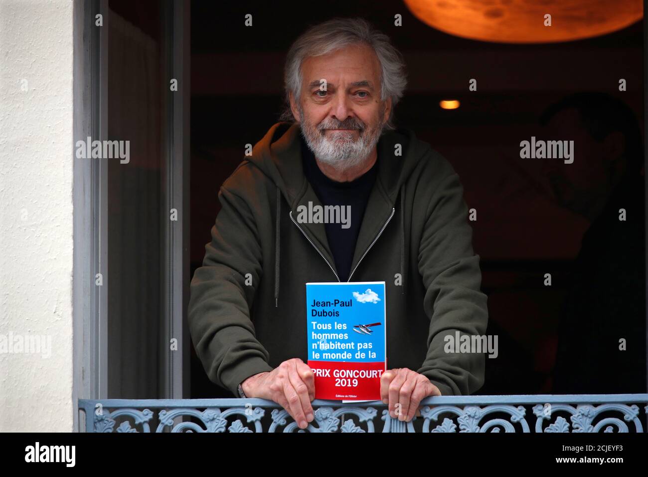 French writer Jean-Paul Dubois poses at the Drouant restaurant after he  received the French literary prize Prix Goncourt for his novel "Tous les  hommes n'habitent pas le monde de la meme facon" (