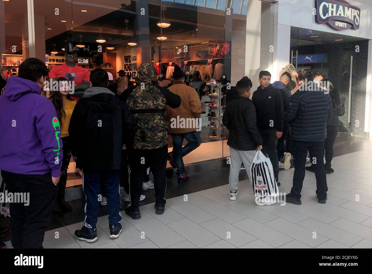 Shoppers Wait In Line To Enter The Champs Sports Retail Store During The Black Friday Sales Event At Roosevelt Field Mall In Garden City New York U S November 29 2019 Reuters Shannon Stapleton