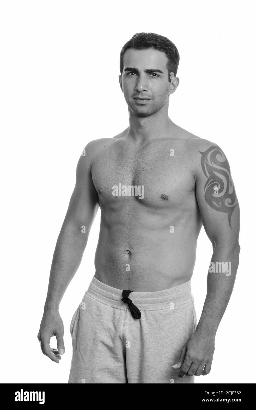 Studio shot of young handsome muscular Persian man shirtless Stock