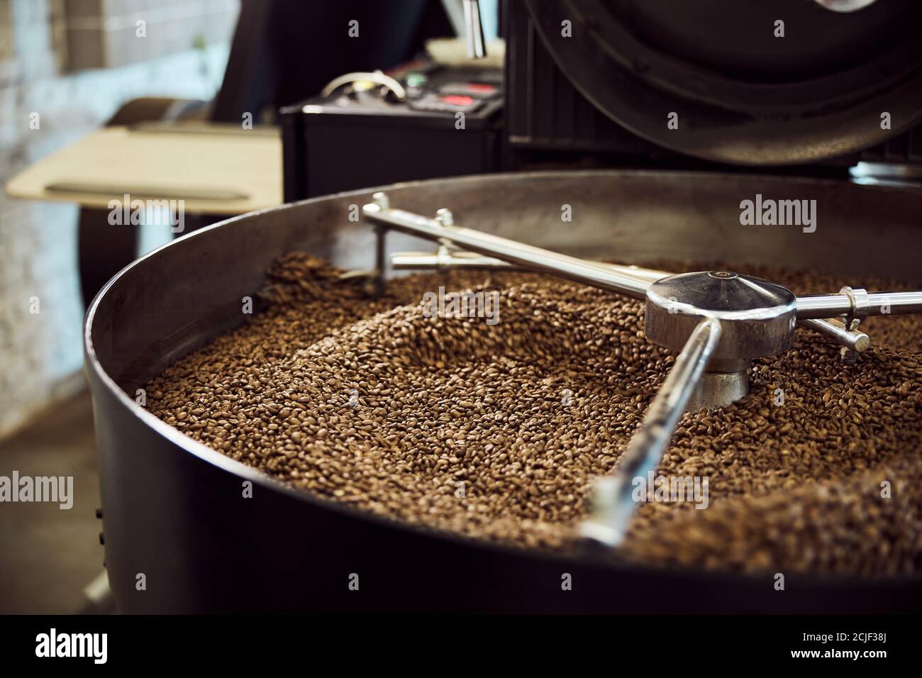 Freshly roasted arabica coffee beans in cooling tray Stock Photo - Alamy