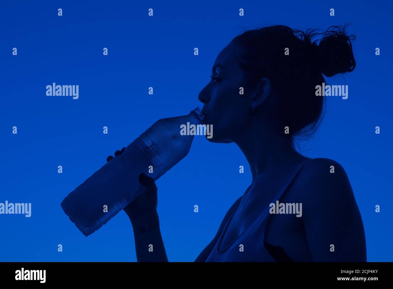 Close up portrait of a young woman drinking water from bottle Stock Photo