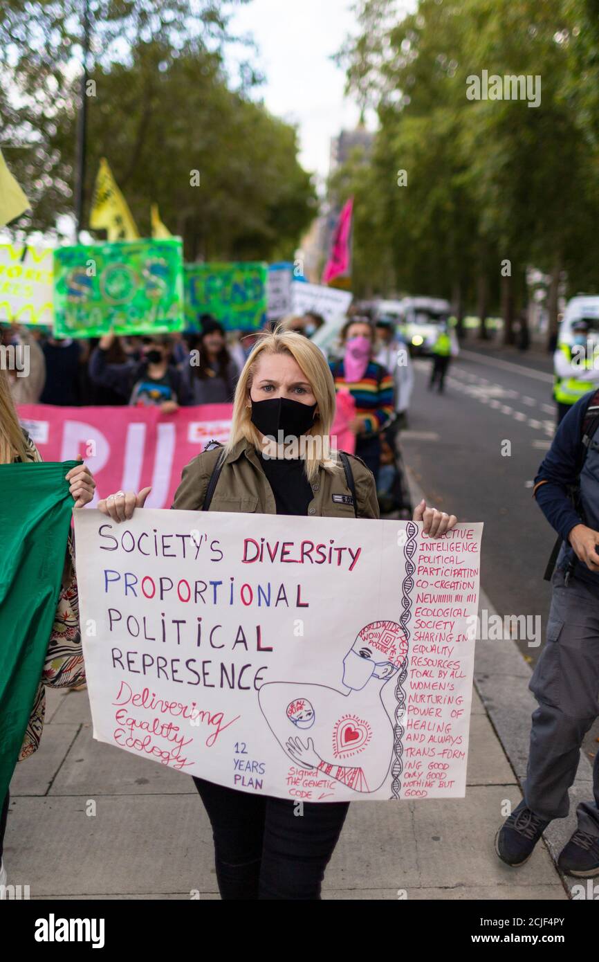 Woman with placard 'Rebels for Amazonia' Extinction Rebellion march on Indigenous Womens Day, London, 5 September 2020 Stock Photo