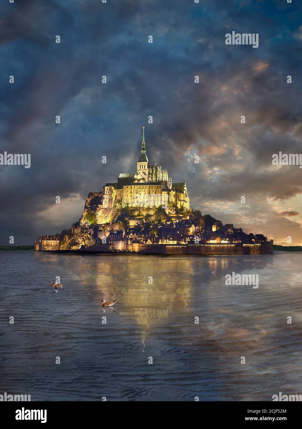 Scenic view of the tidal island  of Mont Saint Michel at night at high tide surrounded and its medieval abbey of Saint Michel. Normandy France.  The t Stock Photo