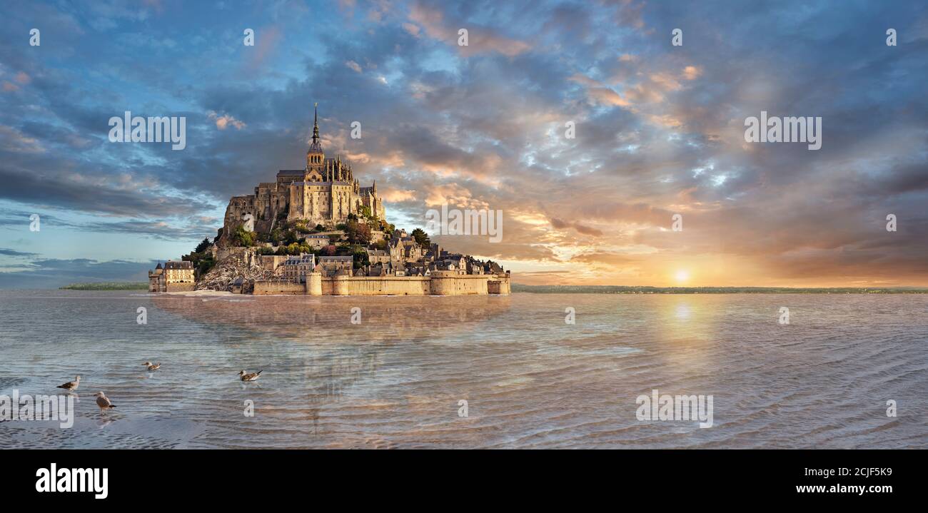 Scenic sunset view of the tidal island  of Mont Saint Michel at high tide surrounded and its medieval abbey of Saint Michel. Normandy France.  The tid Stock Photo