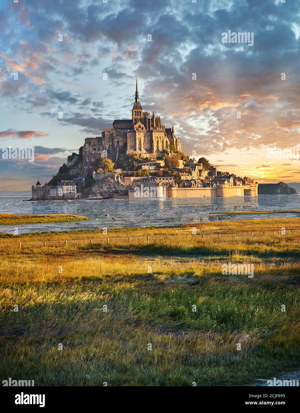 Scenic view of the tidal island  of Mont Saint Michel at high tide surrounded and its medieval abbey of Saint Michel. Normandy France.  The tides vary Stock Photo