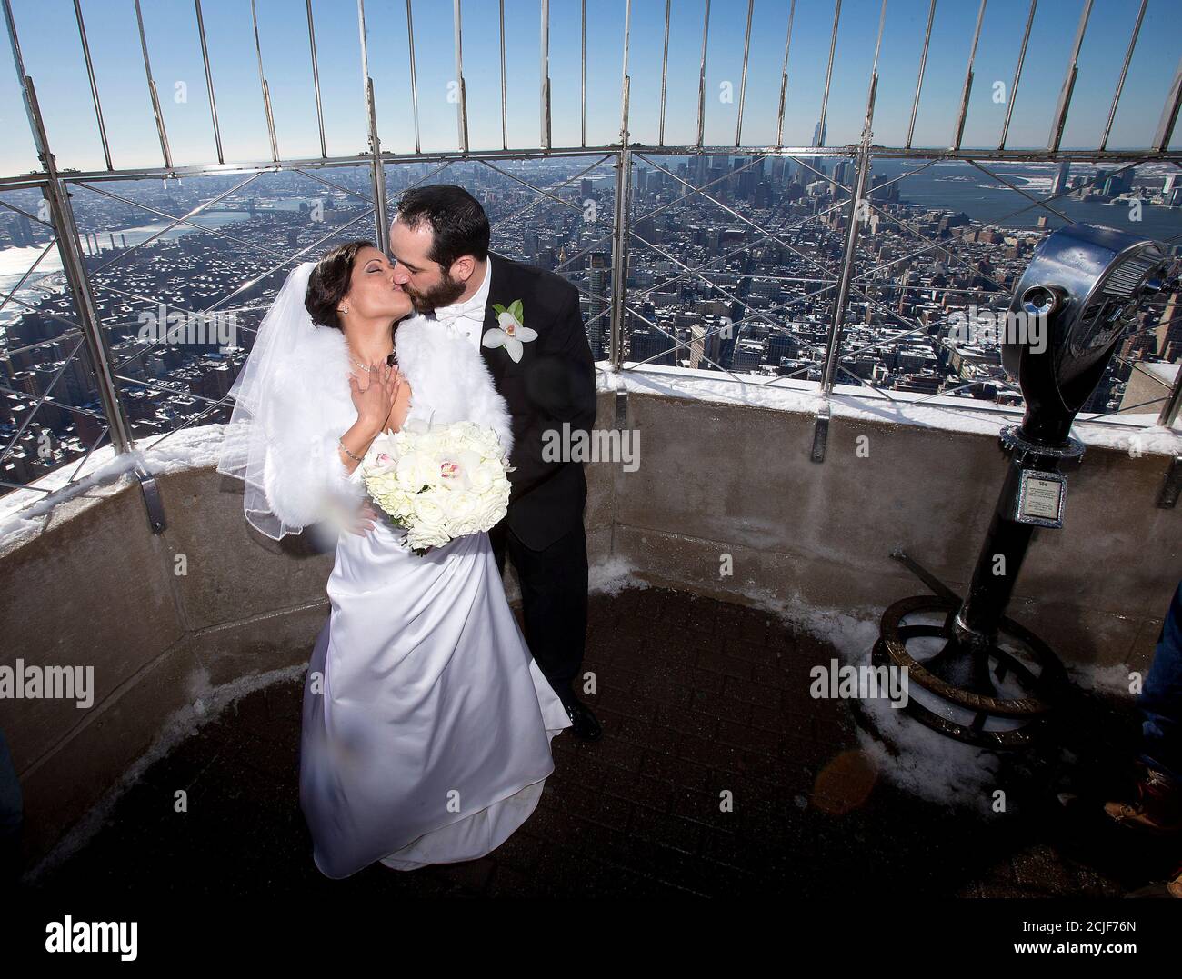 Maria Vasquez and Brendan Goldblatt kiss on the top of the Empire State  Building after getting married in the Manhattan borough of New York  February 14, 2014. The Empire State Building traditionally