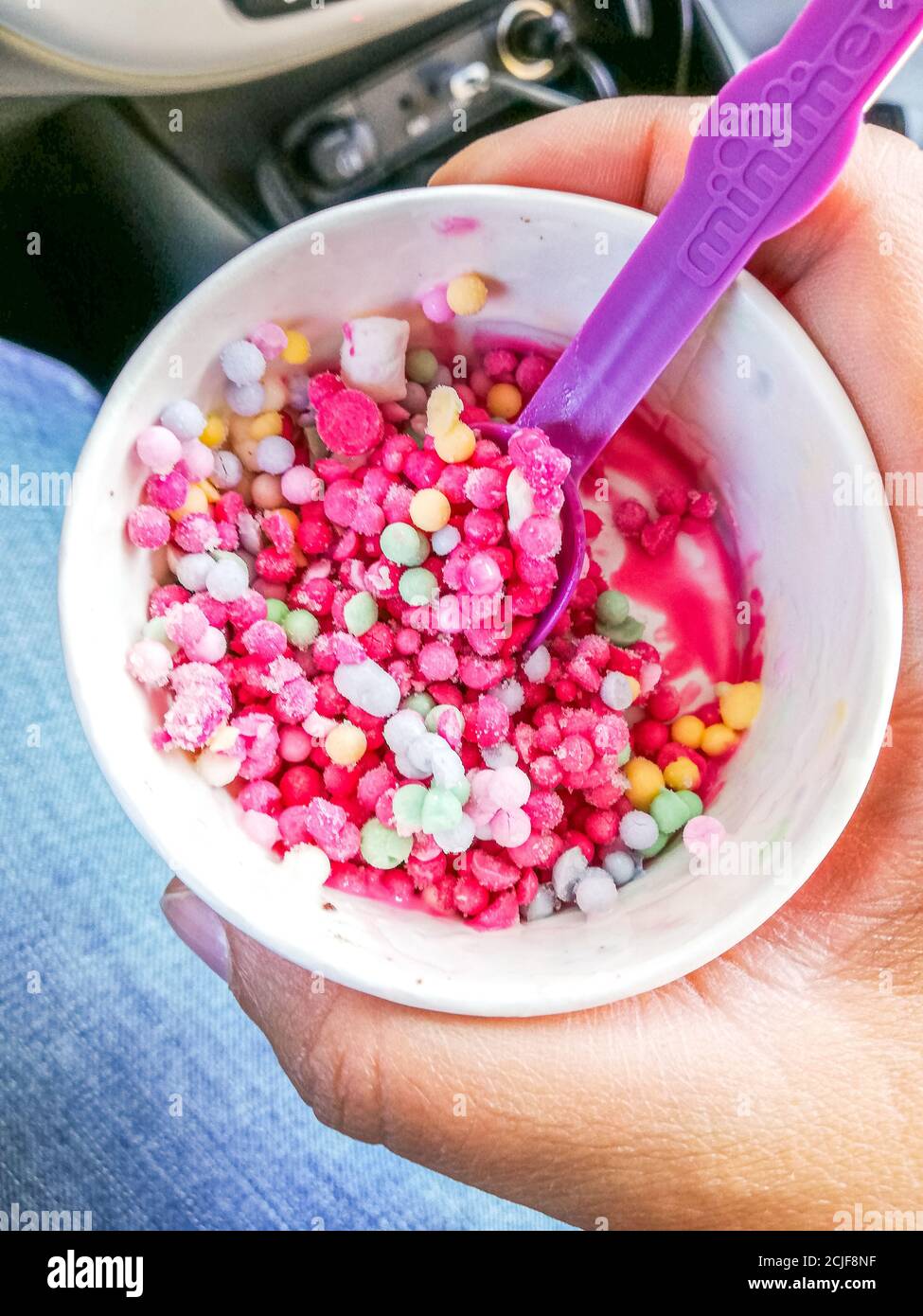 Ice cream mini melts small balls, various flavor icecream dots in small  paper in girl hand Stock Photo - Alamy