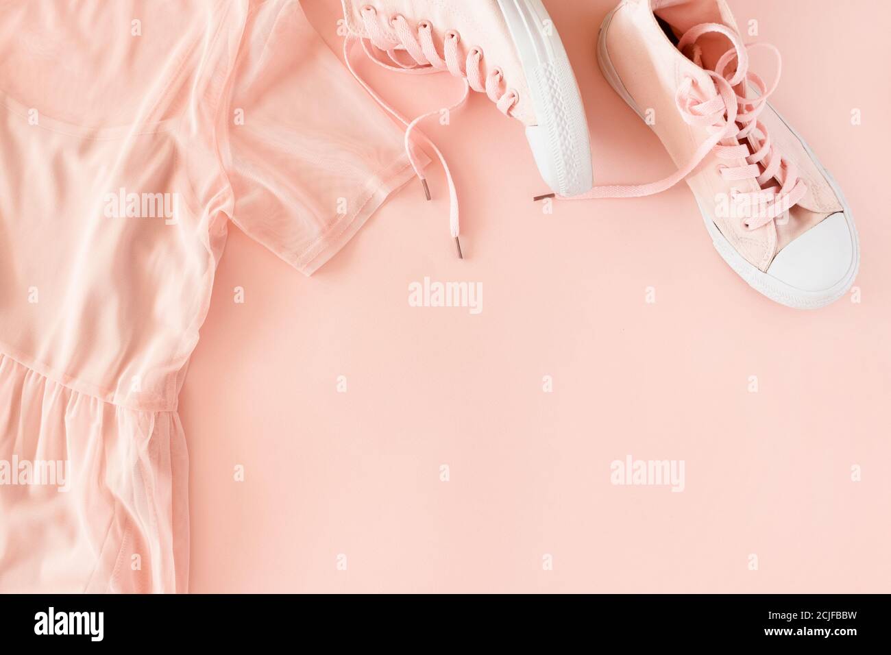 Pink dress and sneakers on a pink pastel background Stock Photo - Alamy
