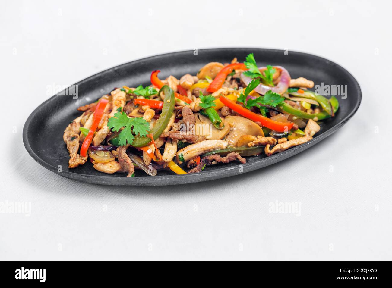 Chicken mushroom and capsicum stir fry recipe served on a sizzling